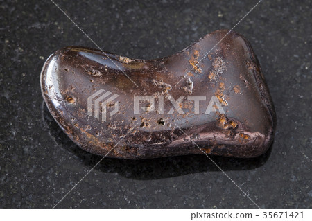 polished hydrogoethite gemstone on dark 35671421