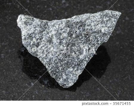 rough olivinite stone on dark background rough olivinite stone on dark background 35671455