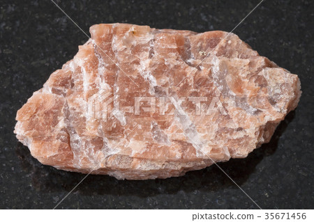 rough pegmatite stone on dark background 35671456
