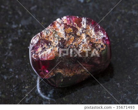 broken red garnet gemstone on dark background broken red garnet gemstone on dark background 35671493