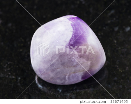 tumbled amethyst gem stone on dark background 35671495