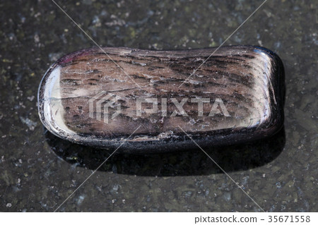 polished Hypersthene gemstone on dark background polished Hypersthene gemstone on dark background 35671558