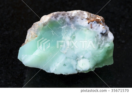 rough crystal of Chrysoprase gemstone on dark 35671570