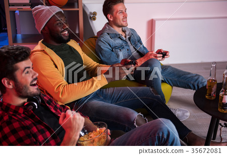 Pleasant positive friends are having fun at home Pleasant positive friends are having fun at home 35672081