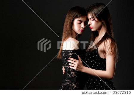 two women in a black dress. Twins 35672510