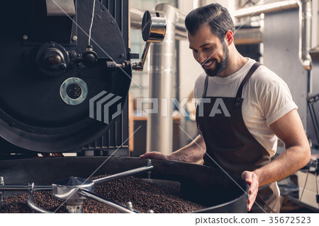 Cheerful male checking brown grains 35672523