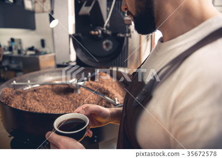 Serene male drinking mug of beverage 35672578