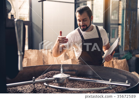 Smiling man enjoying burned beans aroma 35672589