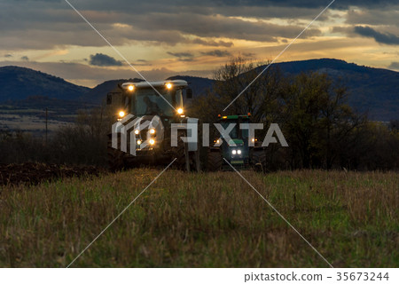 Farmer in tractor preparing land with cultivator Farmer in tractor preparing land with cultivator 35673244