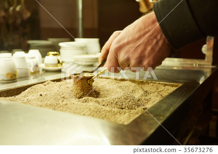 Close up hands of a man cooking turkish coffee on 35673276