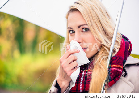 Woman having cold or flu due to bad autumn weather 35673912