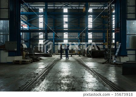 Two workers planning manufacturing process 35673918