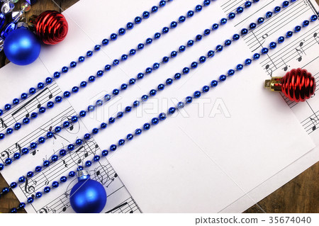 Christmas tree decorations on the table and sheet Christmas tree decorations on the table and sheet 35674040