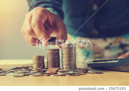 concept saving money with hand putting coins stack concept saving money with hand putting coins stack 35675283