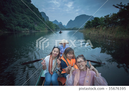 asian woman  sailing boat in tam coc ninh binh 35676395