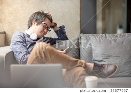 Young Asian man stress while using smartphone 35677967