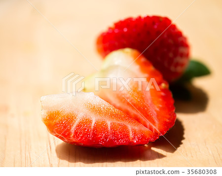 Close up of strawberry on wood. Close up of strawberry on wood. 35680308