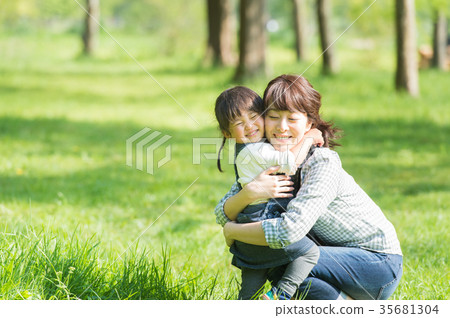 Parent and child playing in the park Parent and child playing in the park 35681304