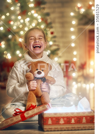 girl with gift near Christmas tree girl with gift near Christmas tree 35681529