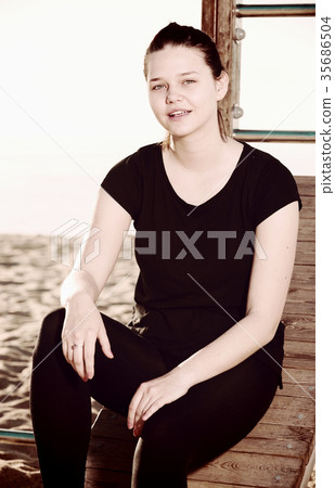 Smiling adult woman is resting after stretching 35686504