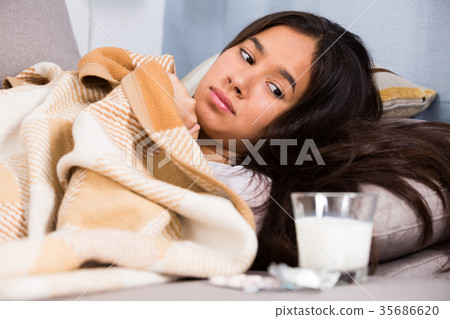 Sick girl at home lying at sofa Sick girl at home lying at sofa 35686620