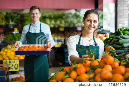 Supermarket workers selling oranges Supermarket workers selling oranges 35686829