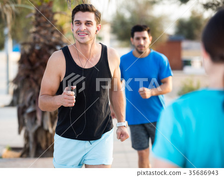 Smiling sportsmen are joggning race in time warm-up 35686943
