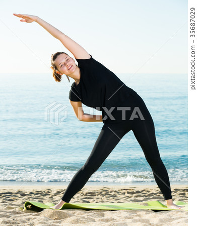 Woman 20-30 years old is practicing stretching in black T-shirt 35687029