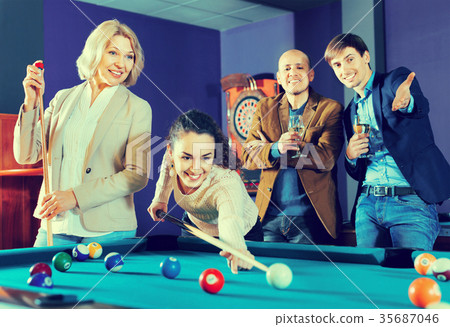 Relaxed people playing billiard and darts as hanging out 35687046