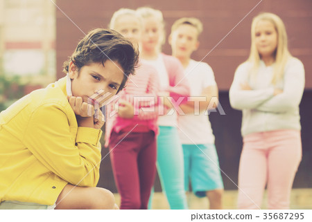 Boy 8-11 years old is outlaw from his friends Boy 8-11 years old is outlaw from his friends 35687295