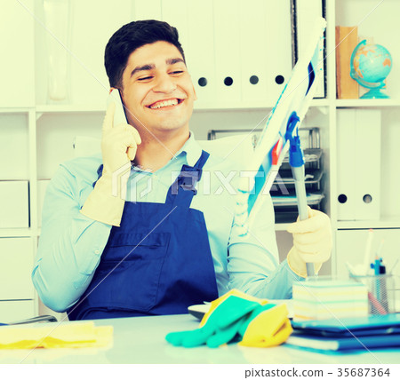 Cleaner is speaking on the phone instead of cleaning 35687364