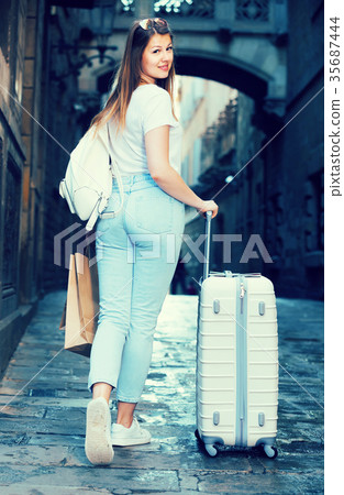 young tourist taking walk in city with the travel bag young tourist taking walk in city with the travel bag 35687444