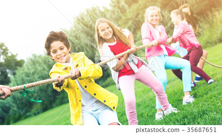 Cheerful children are competing and tug of war Cheerful children are competing and tug of war 35687651
