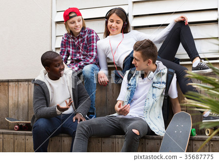 Group of teenage friends relaxing and chatting 35687775
