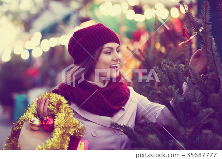 Woman choosing New Year's tree 35687777