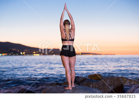 Female 24-31 years old is practicing stretching Female 24-31 years old is practicing stretching 35687815