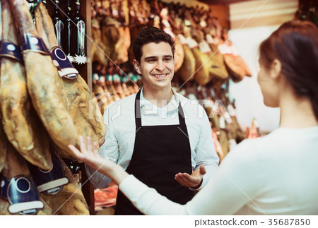 Female customer buying Spanish jamon Female customer buying Spanish jamon 35687850