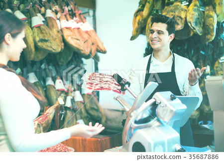 Female customer buying Spanish jamon Female customer buying Spanish jamon 35687886