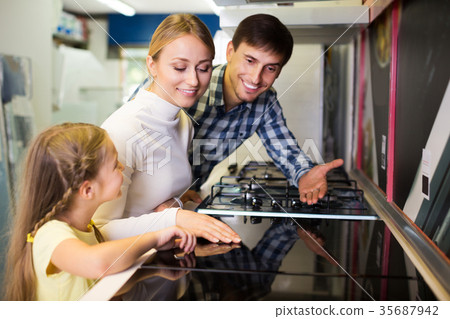 Family buying modern cookstove 35687942