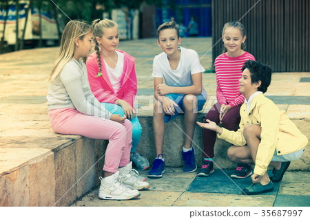 boys and girls are communicating outdoor 35687997