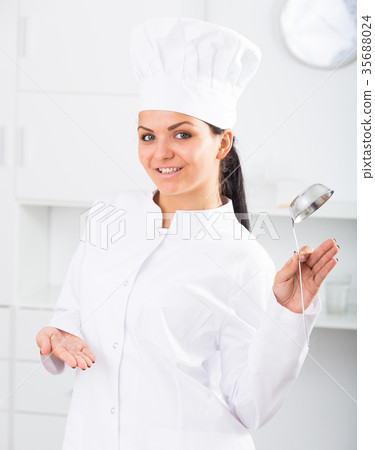 Woman cook with metal scoop 35688024