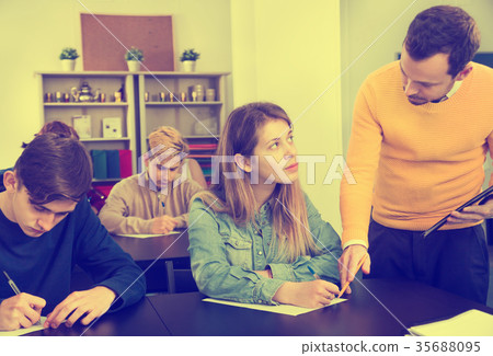 Teacher explaining difficult problem to student 35688095