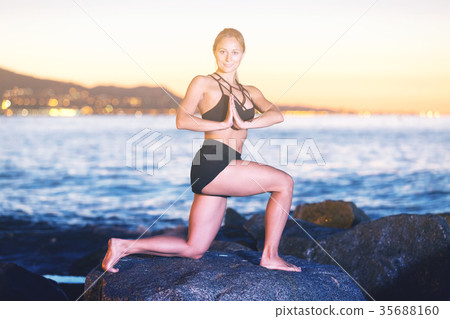 Female 24-31 years old is practicing stretching Female 24-31 years old is practicing stretching 35688160