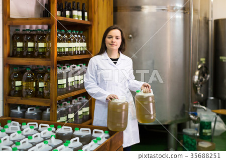 Woman near oil bottles 35688251