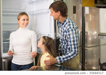 Smiling family with kid in store 35688317