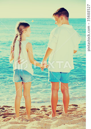 boy and girl standing beach 35688527