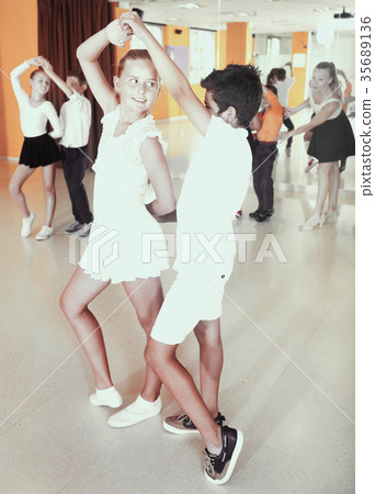 Little boys and girls having dancing class in classroom Little boys and girls having dancing class in classroom 35689136