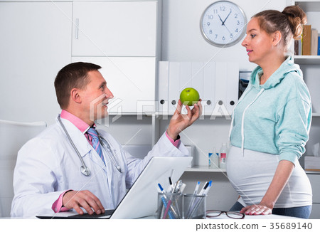 Doctor and pregnant visitor Doctor and pregnant visitor 35689140