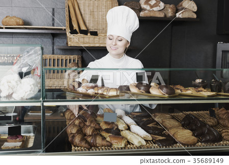 Girl cook gladly suggesting pastry 35689149