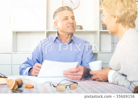 Family of two are discussing and studying important contract Family of two are discussing and studying important contract 35689156